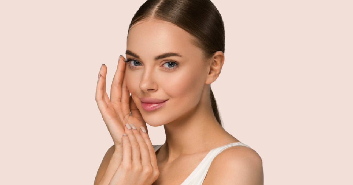 Woman with smooth, youthful skin gently touching her face, representing the natural-looking results of Dysport® Injections in Superior, CO.